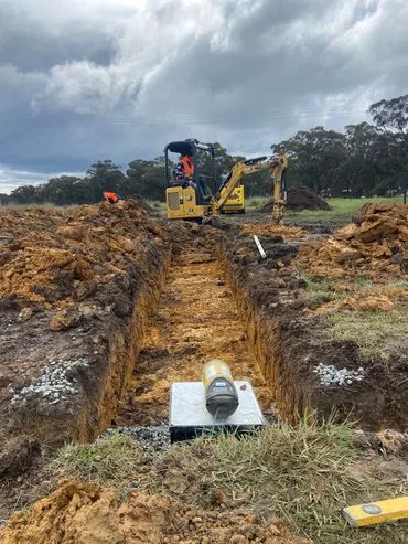 Sewer and septic installation with excavator on a job site